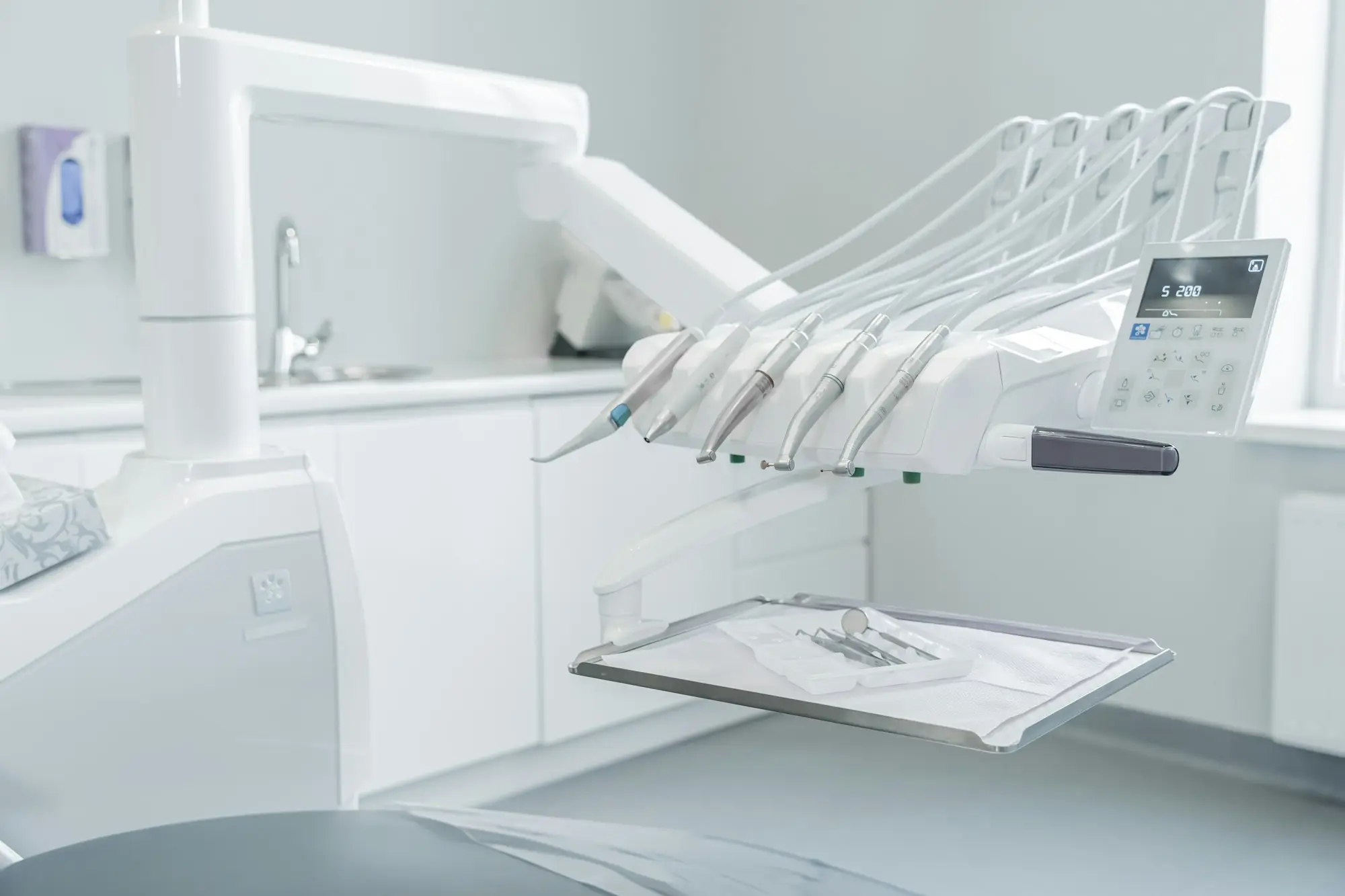 Modern dental chair and equipment in a clean dental surgery
