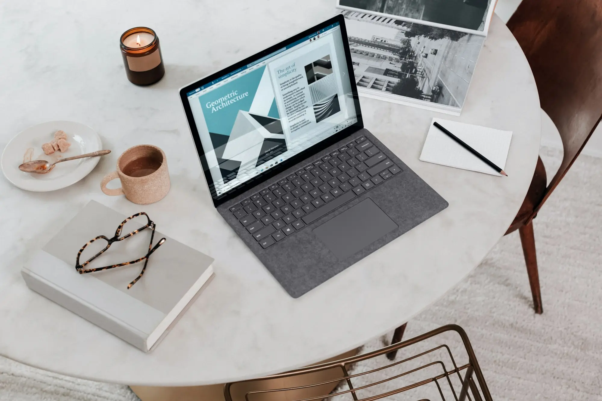 Laptop and notebook on a kitchen table for planning a care business
