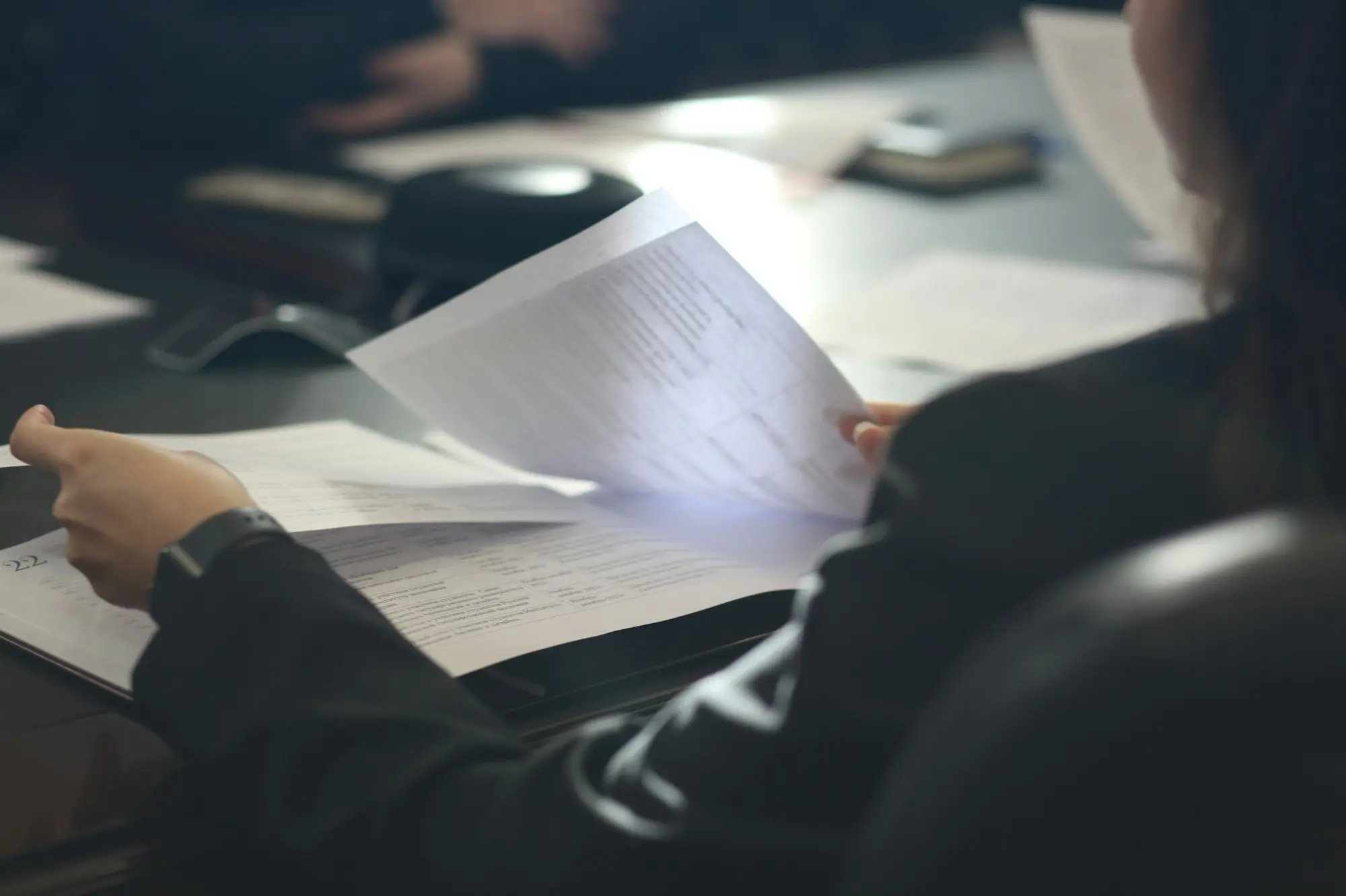 Adviser reviewing documents during a practice purchase meeting